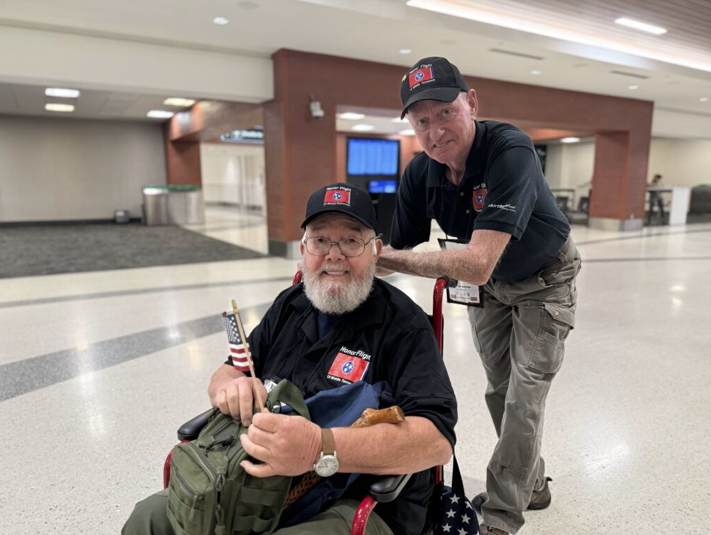 A veteran and their guardian smile together at Nashville International Airport during the Honor Flight event on September 24, 2025.