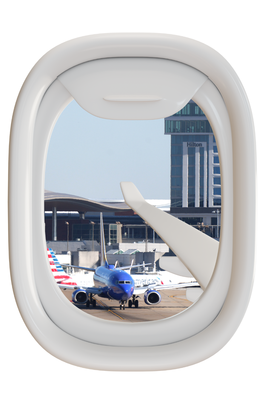 Mock up of an airplane window seat showing the Nashville International Airport terminal and an airplane in view